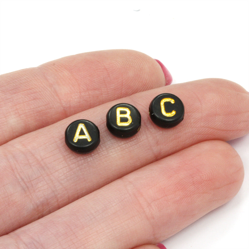 Gold Letters on Black Rounds 4x7mm - Pack of 200